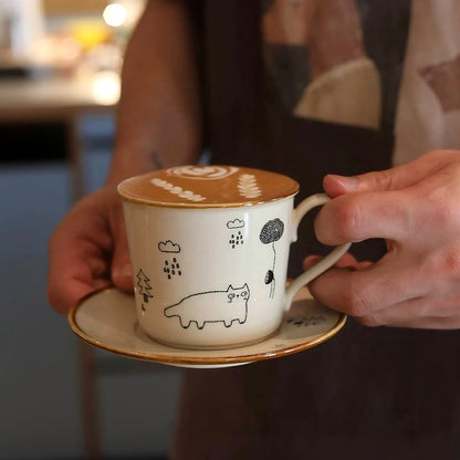Cute hand-illustrated coffee cup with cat and rain theme, round handle design, microwave-safe and dishwasher-safe. Rustic artisan coffee mug suited for Zakka or adorable Scandinavian home style.