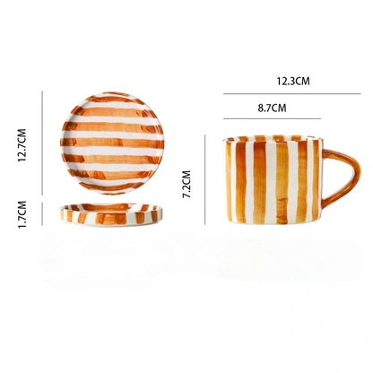Small ceramic plate and cup set with hand-painted burnt orange stripes, ideal for serving desserts, cakes, or appetizers in a Nordic-inspired design.