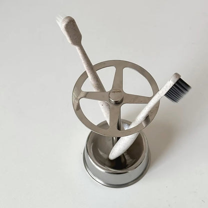 Modern stainless steel brush holder on a bathroom countertop, designed for toothbrushes and blending seamlessly with Scandinavian decor.