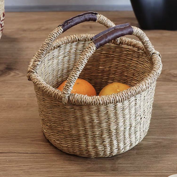 Oval-shaped seaweed basket filled with vegetables, showcasing its natural woven design, perfect for rustic or cottage-inspired interiors.