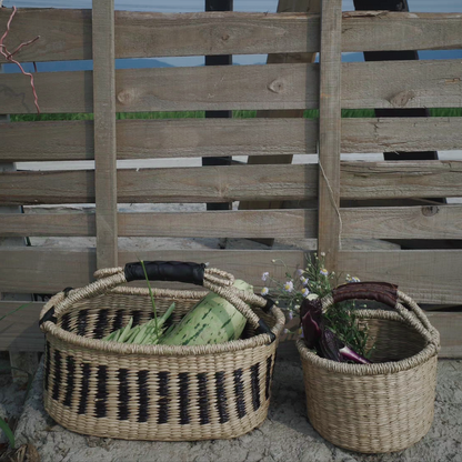 Hand-woven natural seaweed baskets filled with various vegetables, demonstrating its functional and decorative use in the kitchen and outdoors.