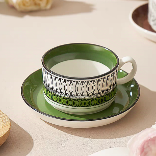 A geometric-patterned green ceramic mug and saucer, ideal for modern tableware collections. Crafted from premium ceramic.