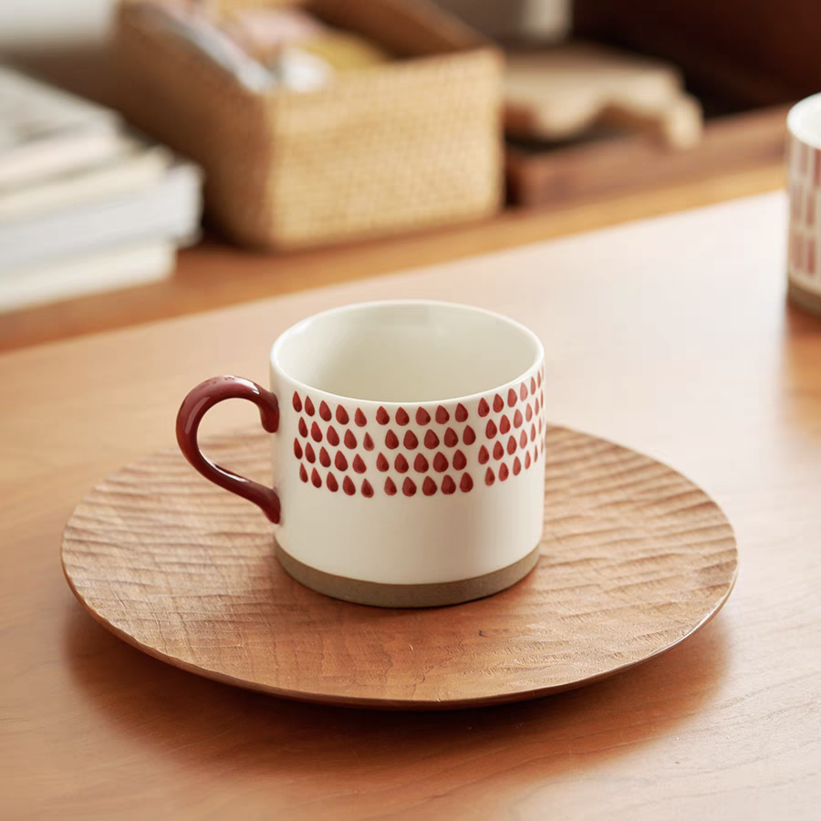 Elegant mug with a vibrant red geometric pattern, enhancing your coffee-drinking experience.