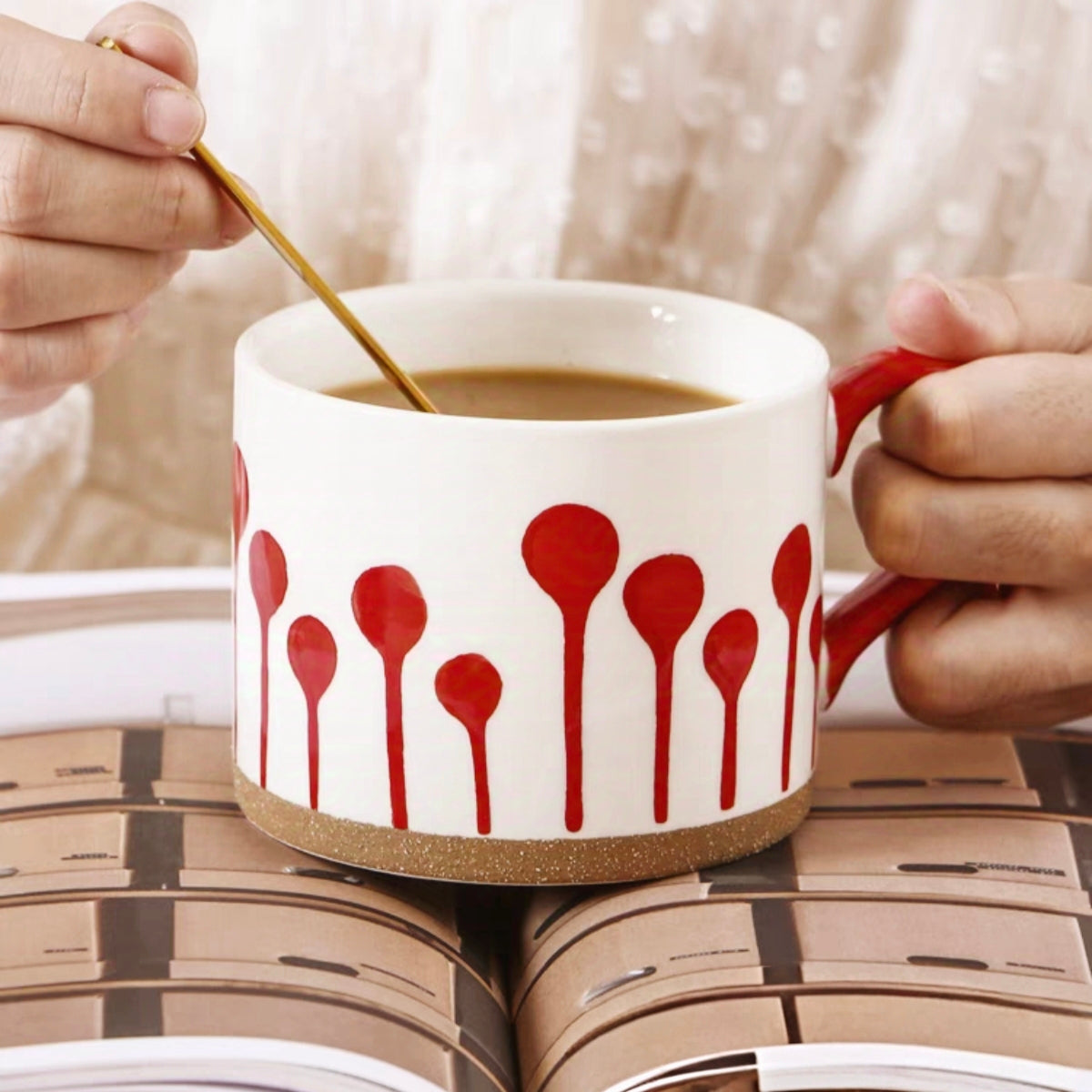 Stylish red and white mug with a natural ceramic finish, suitable for cozy table settings.