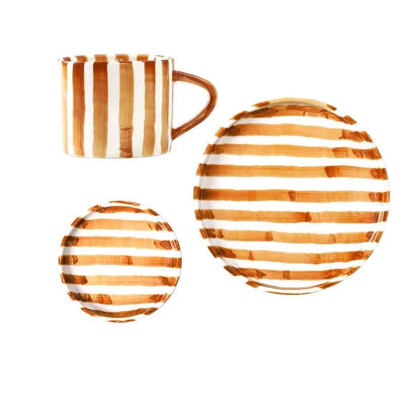 Complete ceramic set featuring a cup with two matching plates in hand-painted burnt orange stripes, designed for serving beverages, cakes, and desserts in a stylish Nordic style.