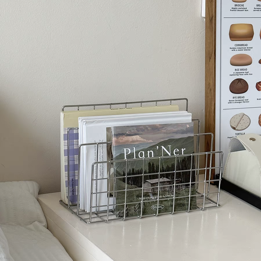 Storing books, notebooks, and a laptop in a aesthetic bedroom, combining modern aesthetics with practical metal shelving.