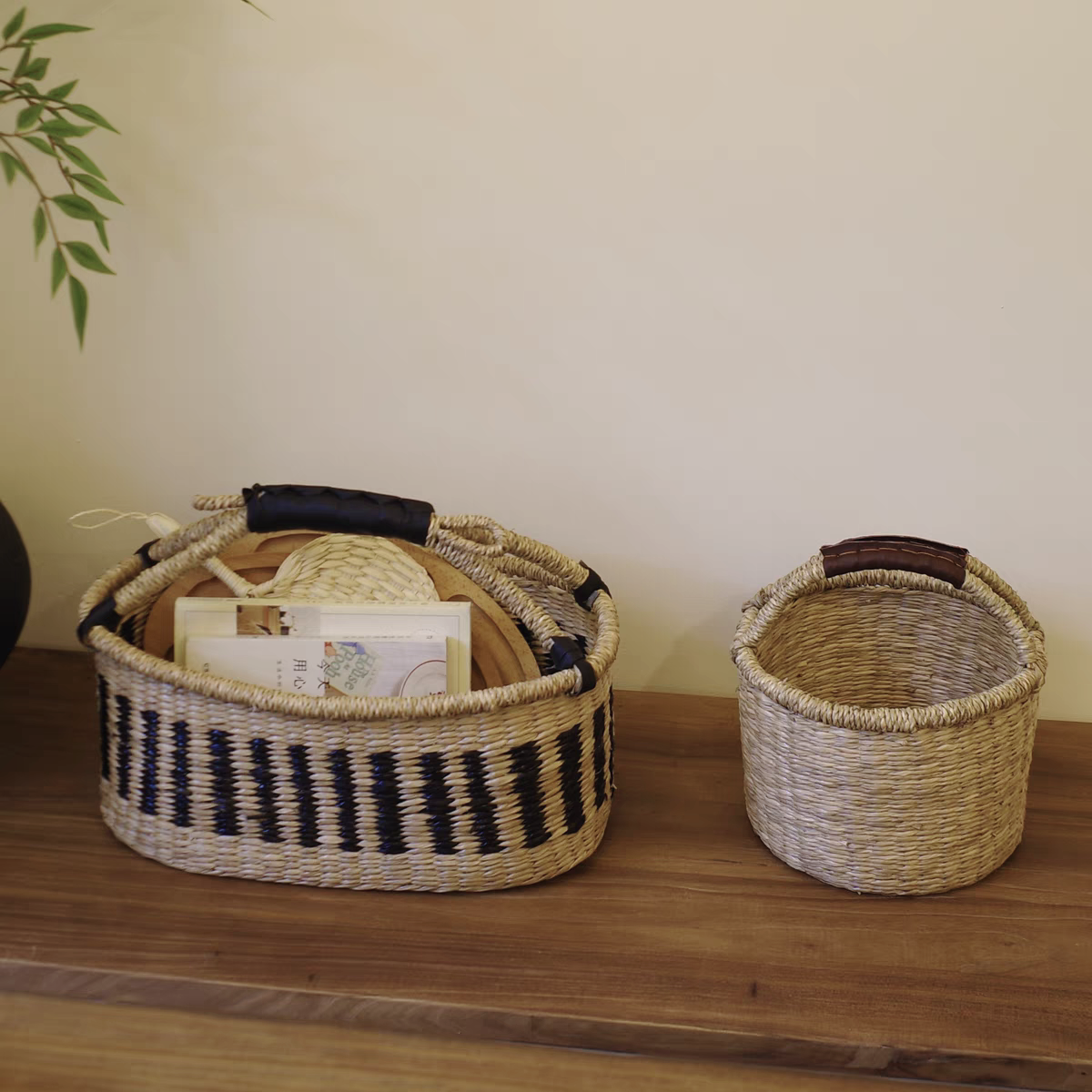 Showing both the black stripe pattern and plain design, these natural seaweed woven baskets offer eco-friendly and stylish storage.