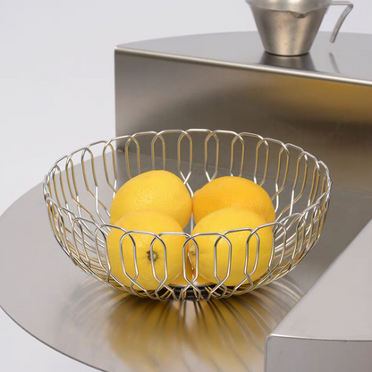 A sleek stainless steel basket filled with fresh lemon, showcasing its modern minimalist design and durable material.