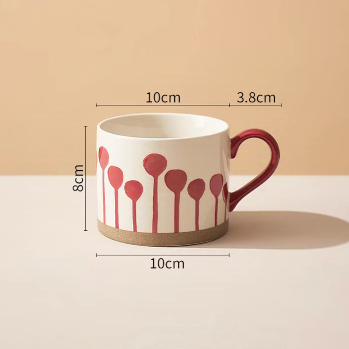 Minimalist ceramic mug with eye-catching red balloon patterns, perfect for hot or cold beverages.