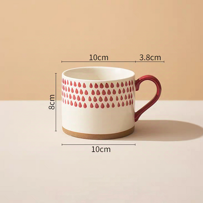 Earthy ceramic mug featuring minimalist red strokes and a smooth interior for easy cleaning.