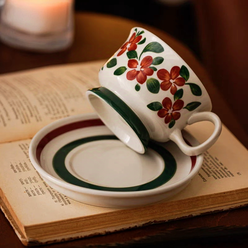 Floral ceramic cup set styled on the table, perfect for coffee, tea, milk, and hot chocolate. Featuring artistic red flower motif.