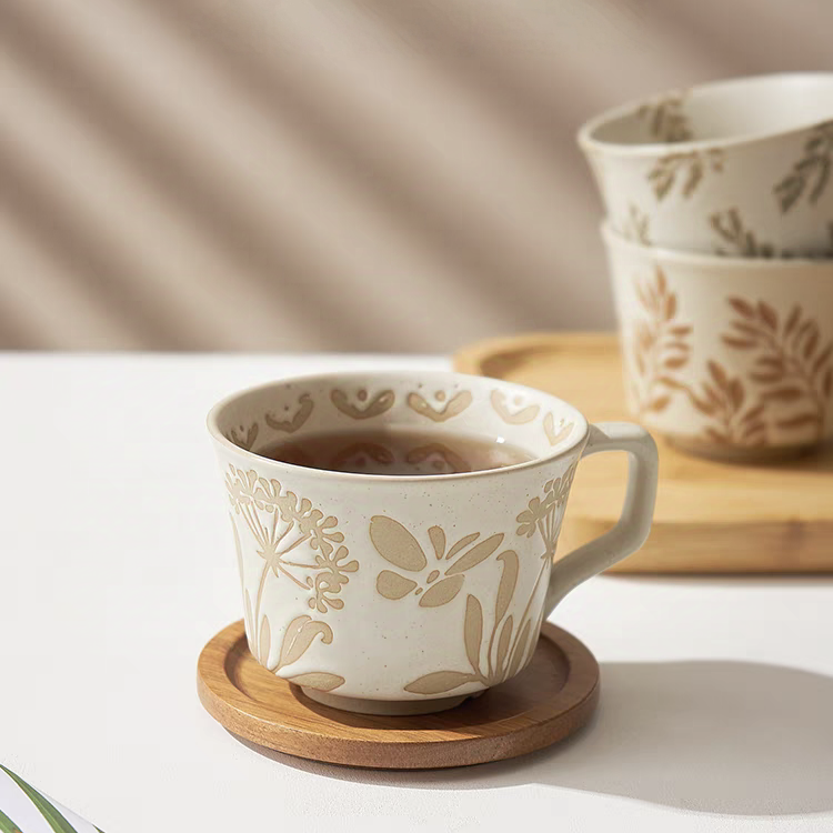 Ceramic mug with textured surface and unique butterfly and floral patterns, ideal for coffee, tea, and decor.