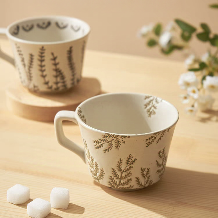 Elegant designed mugs featuring minimalist patterns of leaves and butterflies, perfect for Japandi, cottage, and Nordic styles.