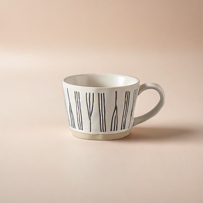 Hand-crafted ceramic mug with a smooth textured surface, featuring a Nordic abstract pattern, ideal for coffee and tea lovers. 