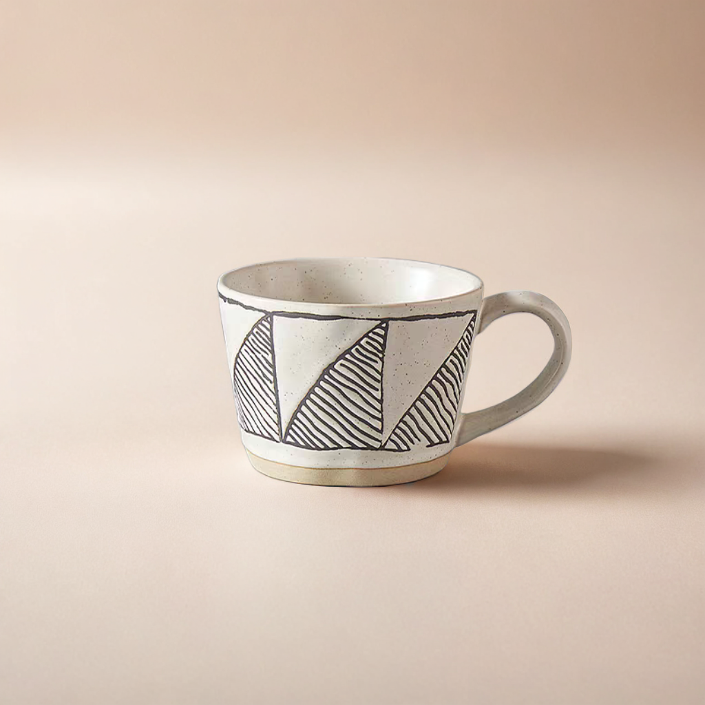 Handcrafted ceramic mug with abstract  triangle patterns, ideal for coffee, tea, and milk in stylish, minimalist, Nordic, rustic settings.