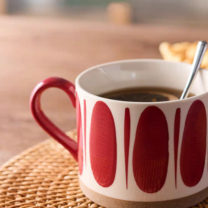 Red and beige ceramic mug with a hand-painted pattern, offering a cozy and chic aesthetic. Comfortable handle, easy to clean.