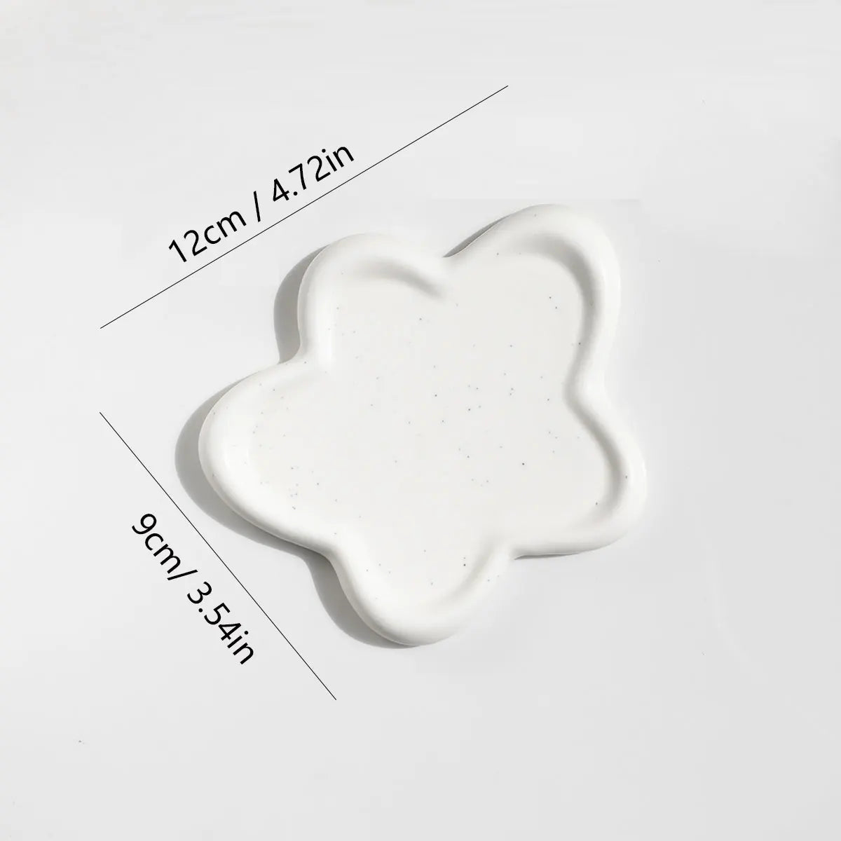 White star-shaped ceramic tray, showcasing its compact size and smooth, modern design, perfect for organizing small jewellery and keys.