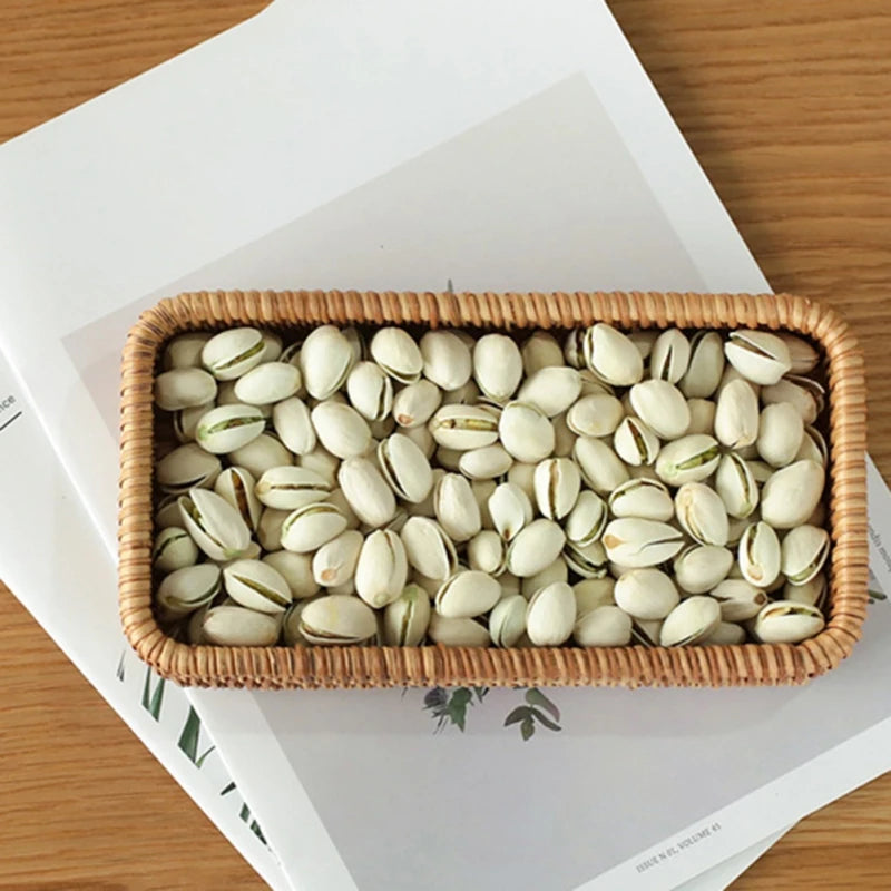 Natural rattan storage tray used for holding dried fruits and snacks, perfect for dining room use