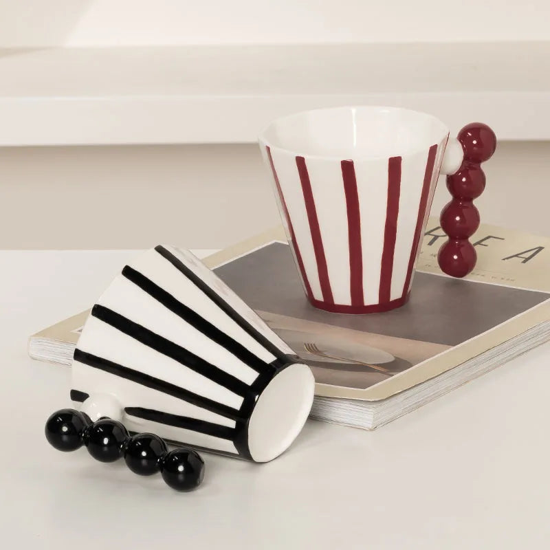 Close-up of Retro Striped Ceramic Mugs in Two Matching Colors - Highlighting the creative handle design and retro striped pattern.