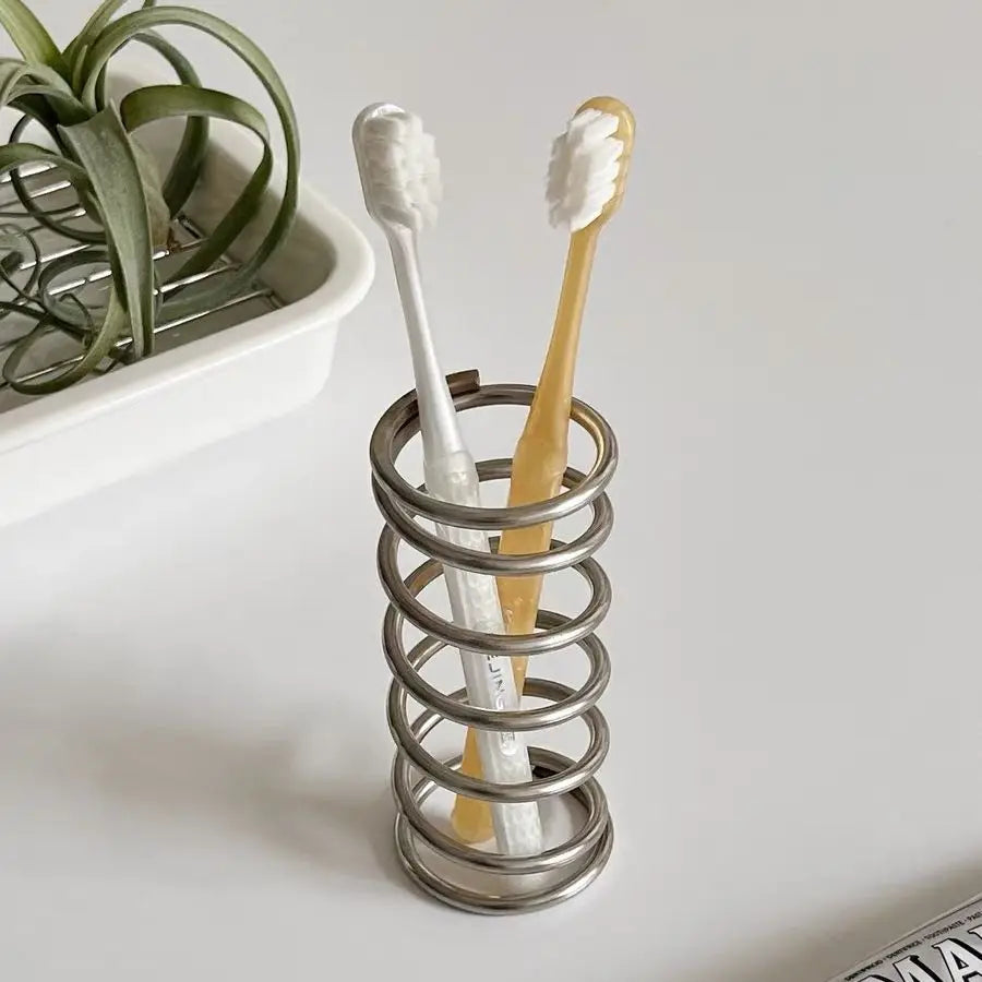 Stylish and functional brush holder for bathroom countertops, ideal for storing makeup brushes and toothbrushes in an organized manner.