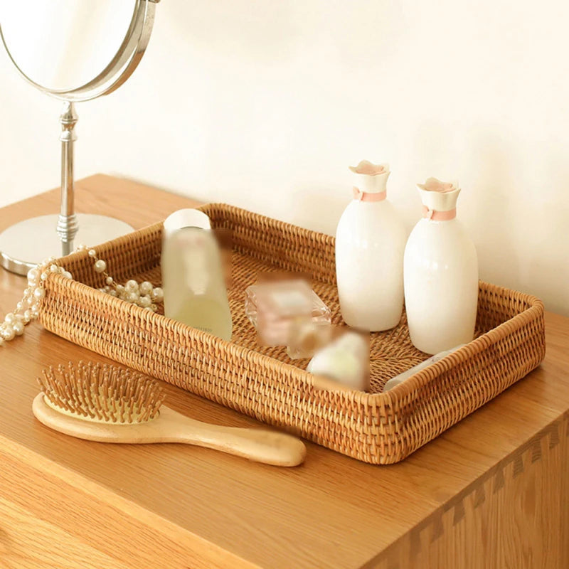 Eco-friendly rattan storage tray organizing cosmetics and skincare products on a vanity table