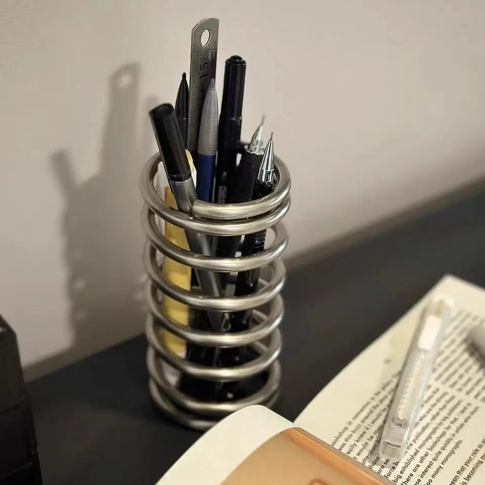 Multi-purpose stainless steel brush holder, perfect for organizing makeup brushes, toothbrushes, and pens on your bathroom countertop or desk.