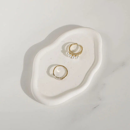 White ceramic oval tray with a sleek and modern design, highlighting its durable material and stylish appearance for jewellery and key storage.