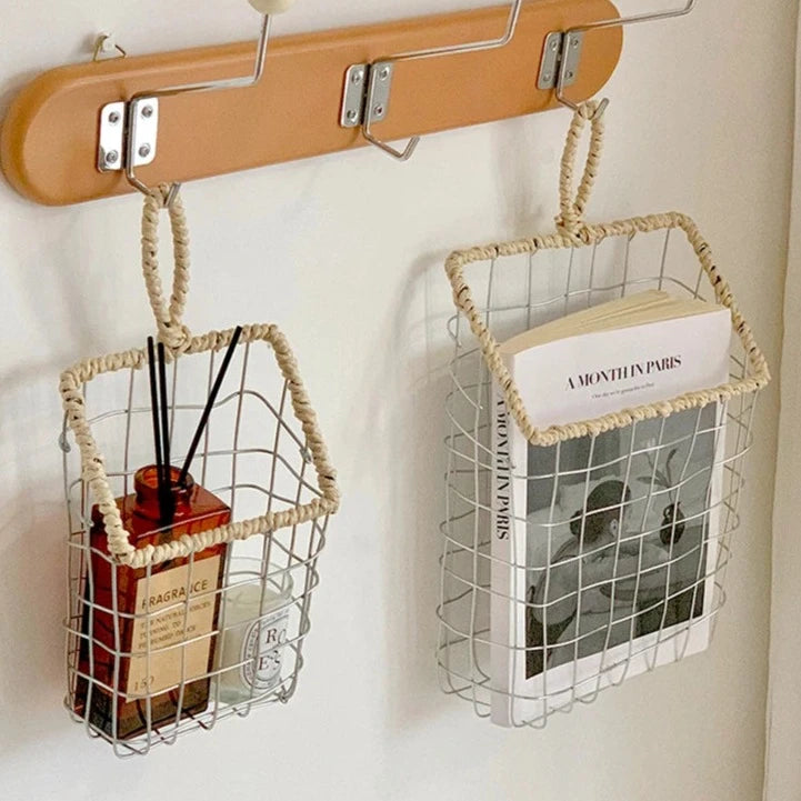 Hanging woven metal wire storage basket on hallway hook, storing everyday essentials, showcasing Scandinavian minimalism.