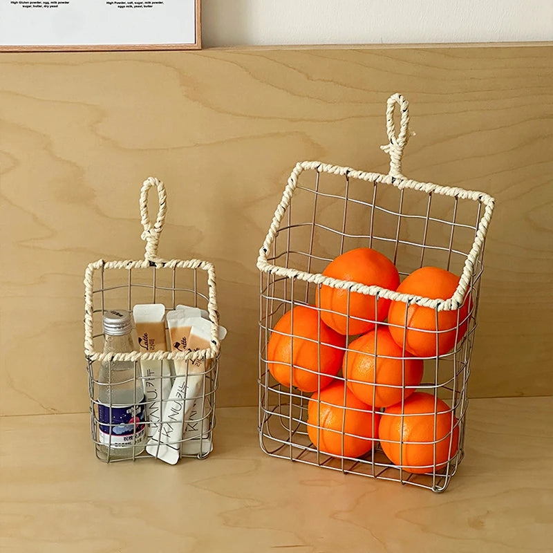 Eco-friendly metal wire storage basket in the kitchen, hanging on a hook, storing fruit and vegetables, perfect for contemporary homes.