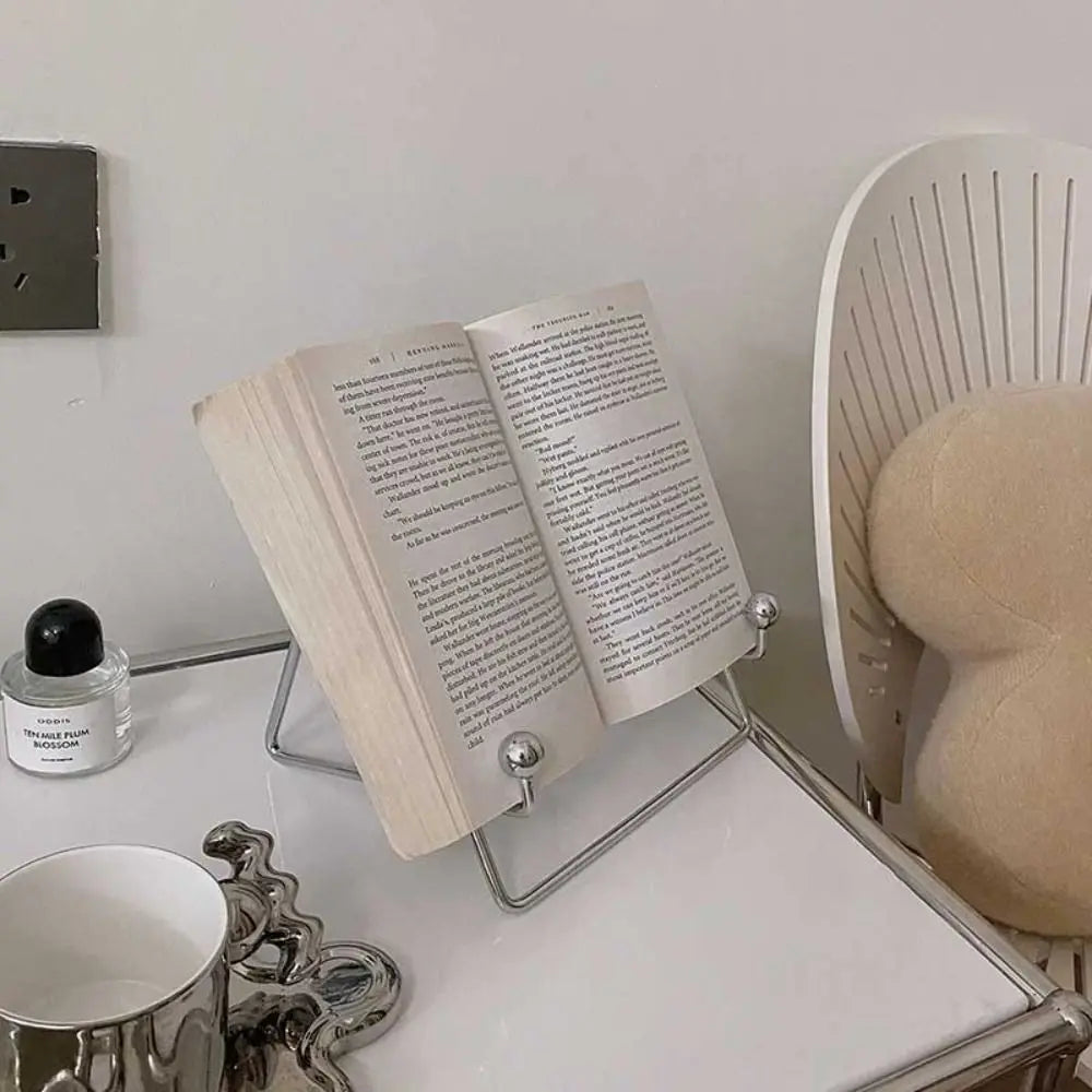 Elegant stainless steel desktop stand in silver, supporting a book