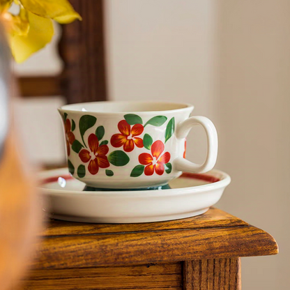 Scandinavian-style floral ceramic cup placed on a wooden table, blending natural aesthetics and functionality.