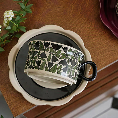 Minimalist coffee mug and saucer featuring Nordic black and green floral motif, perfect for cozy home interiors. Microwave, dishwasher and oven safe.