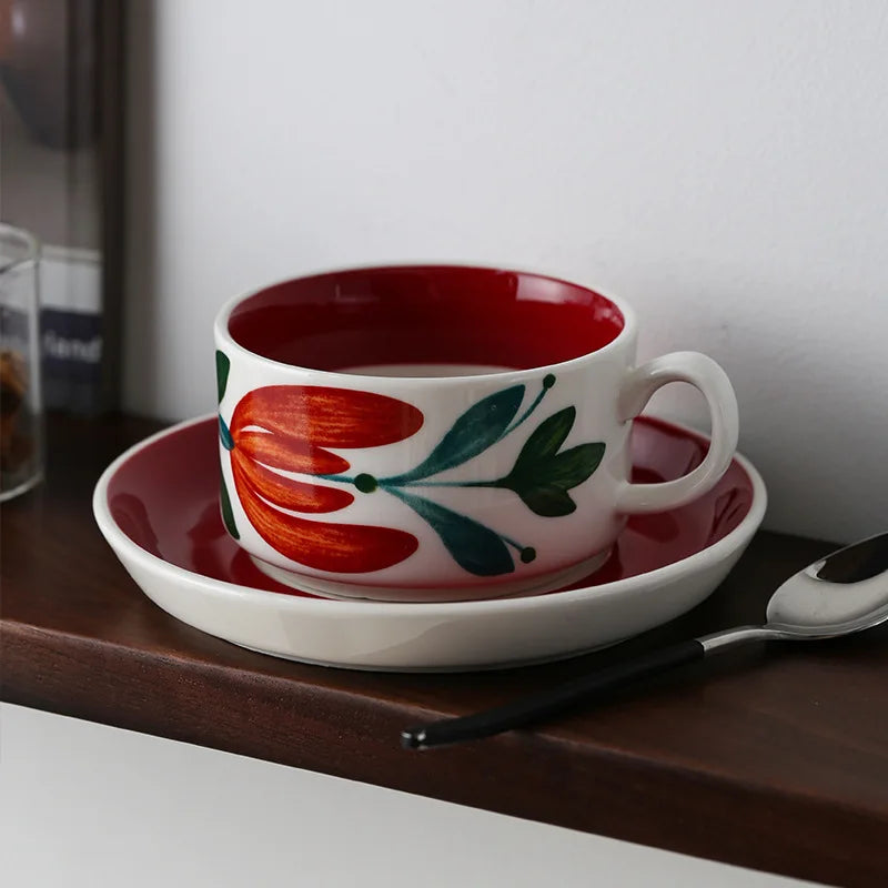 A red ceramic cup with floral patterns, ideal for adding elegance to your tea or coffee moments.