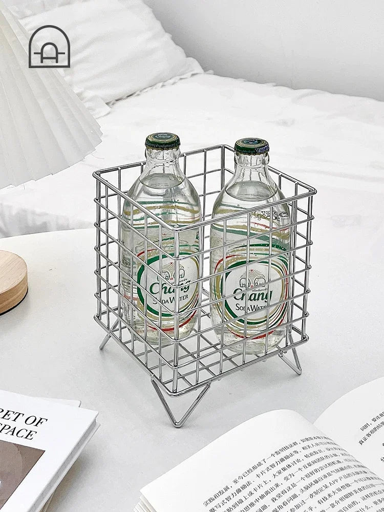 Versatile metal wire basket for storing snacks and beverages.Modern metal wire basket with a sleek finish.