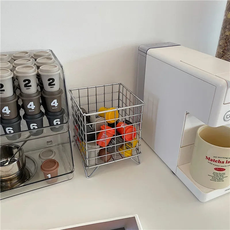 Compact metal wire basket designed for countertop use. Metal wire basket used for organizing coffee capsules in the home coffee corner.