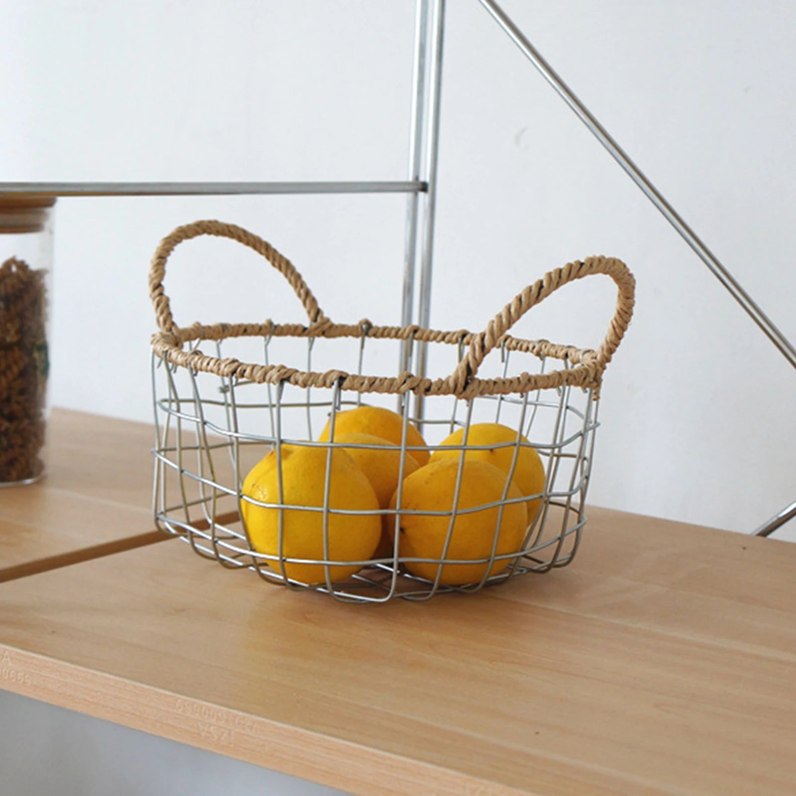 Overview of the round woven metal wire storage basket with handles, highlighting its spacious interior and Scandinavian minimalism design.