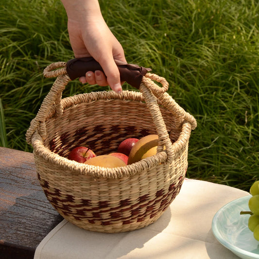 Natural seaweed oval basket filled with fruits, perfect for outdoor picnics with eco-friendly style.