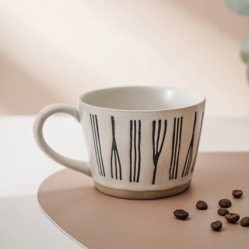 A handcrafted ceramic cup featuring an abstract pattern in neutral tones, reflecting the simplicity and beauty of Scandinavia design.