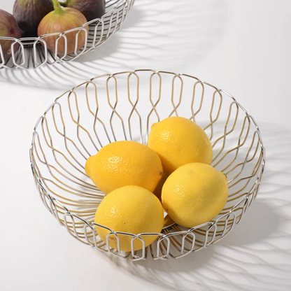 Stainless steel basket filled with lemons, combining functionality and modern aesthetics for kitchen storage.