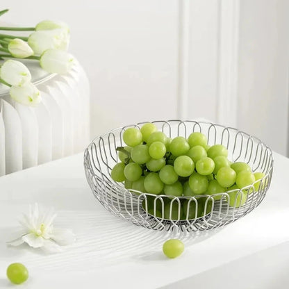 A sleek stainless steel basket filled with fresh grapes, showcasing its modern minimalist design and durable material.