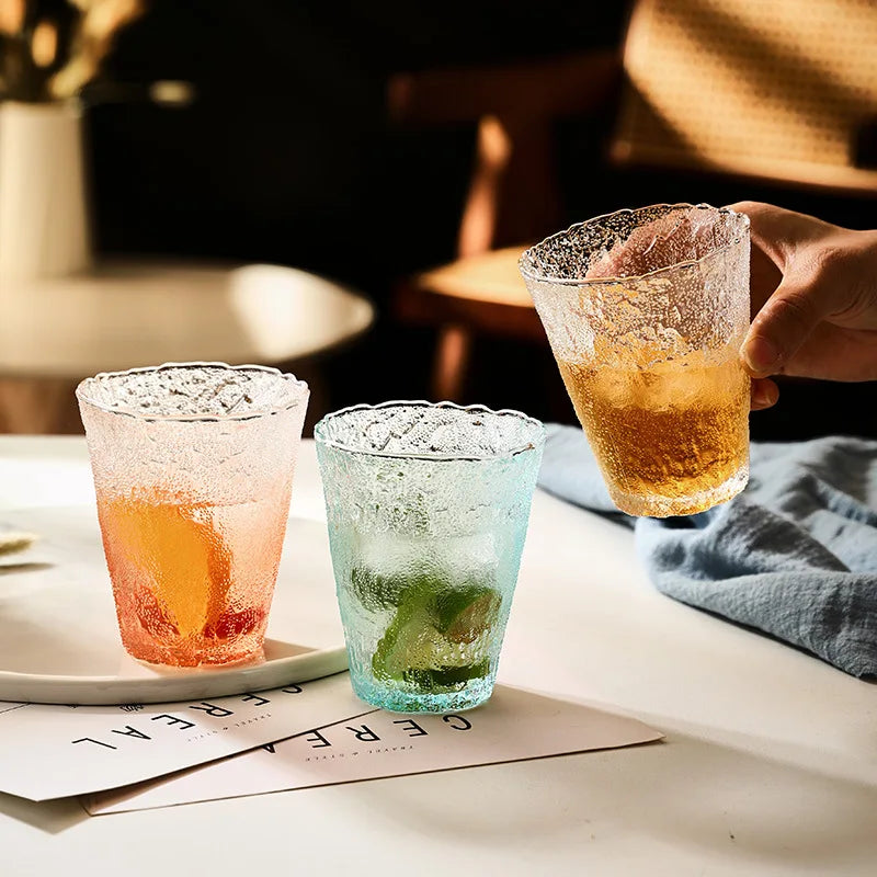 Three gradient glacier glass cups in orange, blue, and clear. Elegant 250ML drinkware for versatile use, including tea, juice, and cocktails.