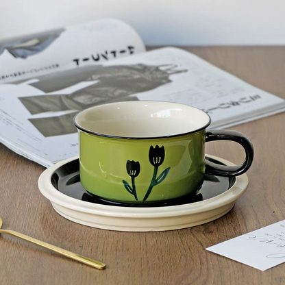 A retro-inspired ceramic coffee cup with a green tulip design, blending modern and vintage aesthetics.