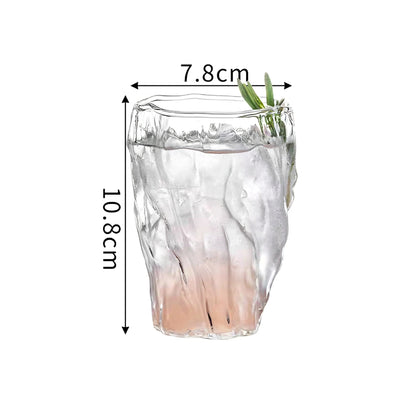 A clear glass cup with crystal texture, ideal for serving sophisticated cocktails in minimalist settings. Height 10.8 cm, diameter 7.8 cm.