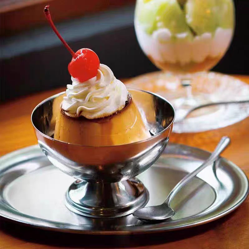 Stainless steel dessert dish holding a creamy pudding, emphasizing its elegant design and versatile use for desserts.