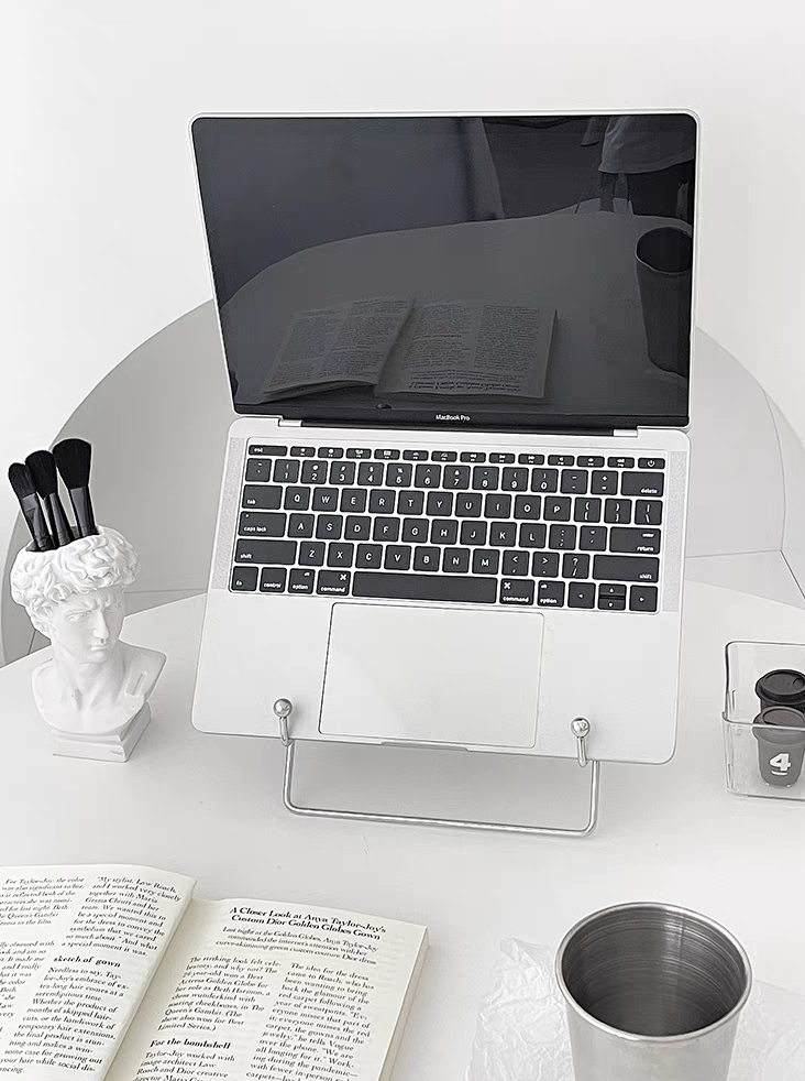 Silver stainless steel desktop stand holding a laptop, ideal for office and study use.